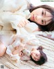 A young woman laying on a rug holding a teddy bear.