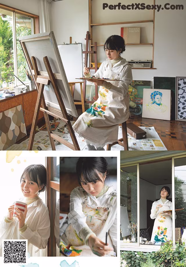 A woman sitting in front of a painting on a easel.